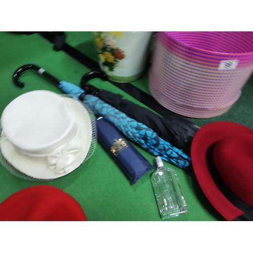 99 - Collection of ladies accessories inc hats along with a wedding hat, umbrellas inc Buckingham Palace ... 