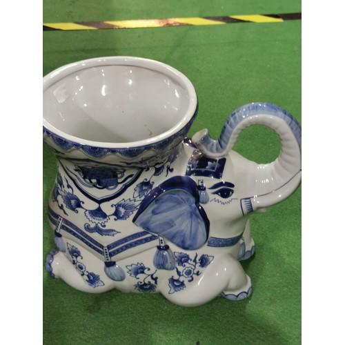 109 - Large ceramic elephant formed planter in a blue and white design. Planter stadns at 31cm high, 38cm ... 