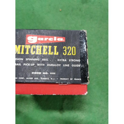 157 - Boxed Mitchell 320 fishing reel along with instruction booklet and additional spool, all in good ord... 