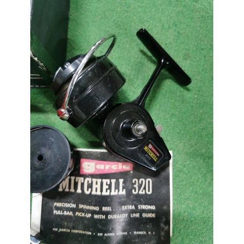 157 - Boxed Mitchell 320 fishing reel along with instruction booklet and additional spool, all in good ord... 