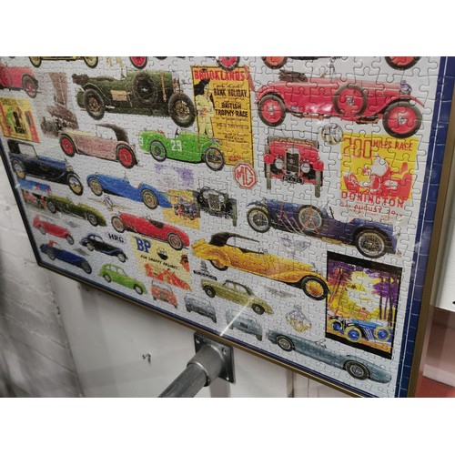 199 - Framed and glazed jigsaw puzzle depicting vintage cars. Height 50cm x 71cm.