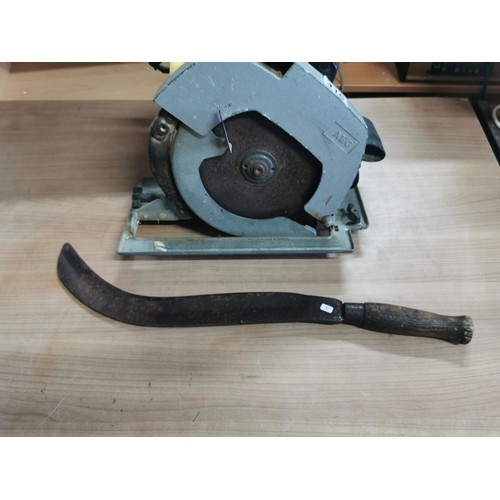 416 - AEG 110w circular saw along with a bill hook. bill hook measures 56cm