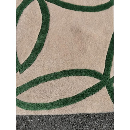 464 - Well made white and green swirl rug. 192cm x 135cm, hand made in wool in excellent clean condition