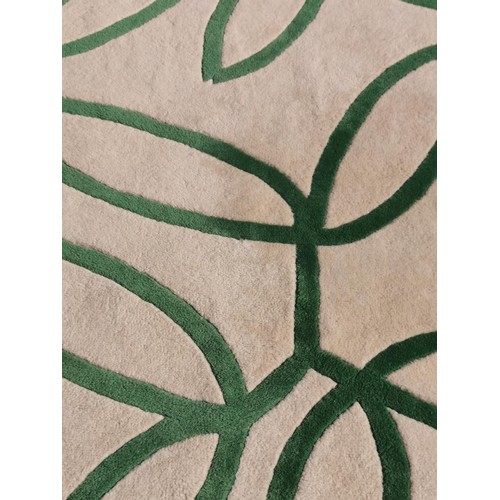 464 - Well made white and green swirl rug. 192cm x 135cm, hand made in wool in excellent clean condition