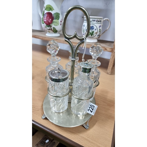 220 - Silver plated cruet set with crystal glass bottles. In excellent condition.