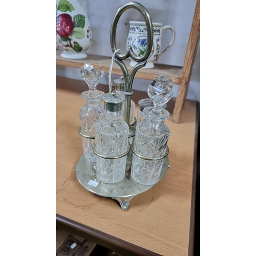 220 - Silver plated cruet set with crystal glass bottles. In excellent condition.