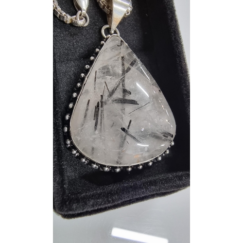 255 - Large 925 Silver pendant inset with a large pear shaped rutilated quartz stone set on a good very lo... 