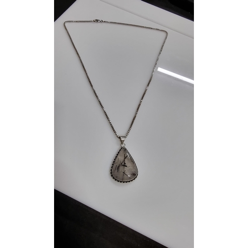 255 - Large 925 Silver pendant inset with a large pear shaped rutilated quartz stone set on a good very lo... 