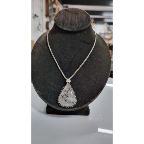 255 - Large 925 Silver pendant inset with a large pear shaped rutilated quartz stone set on a good very lo... 