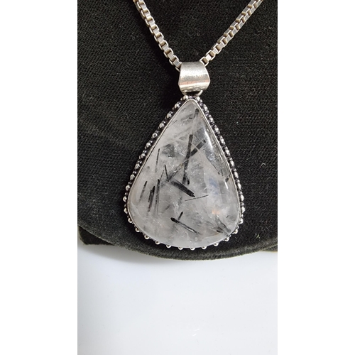 255 - Large 925 Silver pendant inset with a large pear shaped rutilated quartz stone set on a good very lo... 