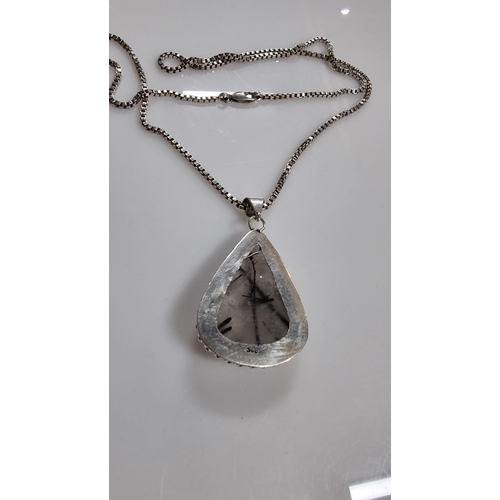 255 - Large 925 Silver pendant inset with a large pear shaped rutilated quartz stone set on a good very lo... 