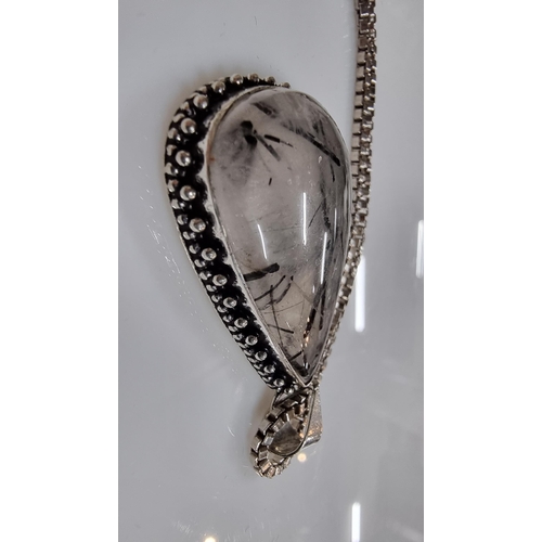 255 - Large 925 Silver pendant inset with a large pear shaped rutilated quartz stone set on a good very lo... 