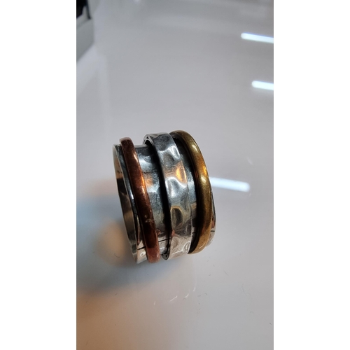 277 - Unusual 925 Silver hand beaten ring with three rotating bands including rose gold plated & yellow go... 