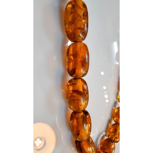 284 - Unusual vintage genuine baltic amber beaded necklace with inclusions with a face, skull carved penda... 