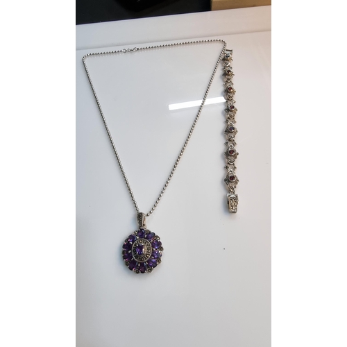 290 - Ornate 925 silver pendant with a striking design inset with a quantity of purple CZ stones & marcasi... 