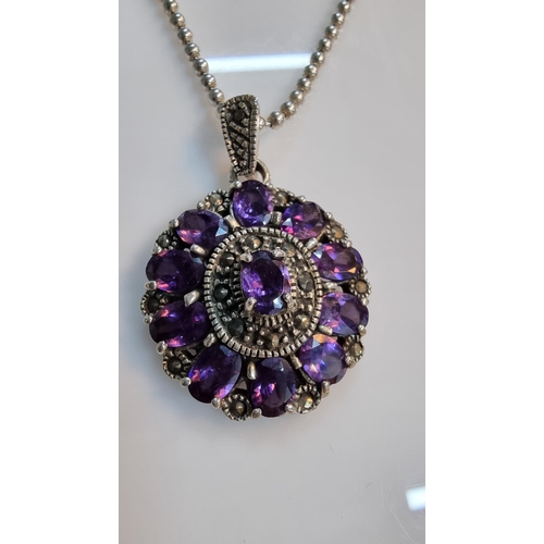 290 - Ornate 925 silver pendant with a striking design inset with a quantity of purple CZ stones & marcasi... 