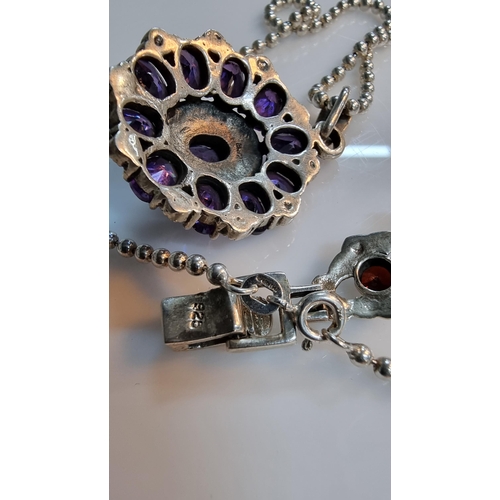 290 - Ornate 925 silver pendant with a striking design inset with a quantity of purple CZ stones & marcasi... 