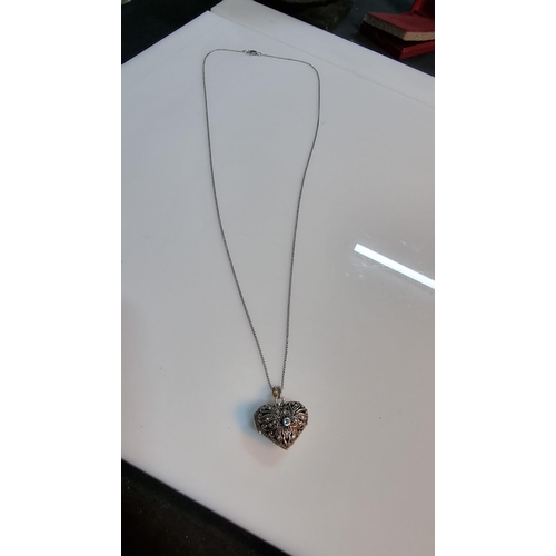 306 - Good quality ornate 925 Silver heart locket pendant with pierced design, with a aquamarine stone to ... 