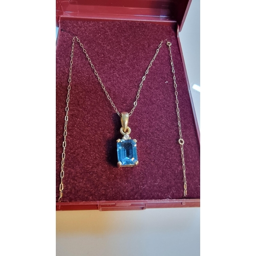 314 - 9ct. gold pendant inset with large cushion cut blue aquamarine stone set on a 18