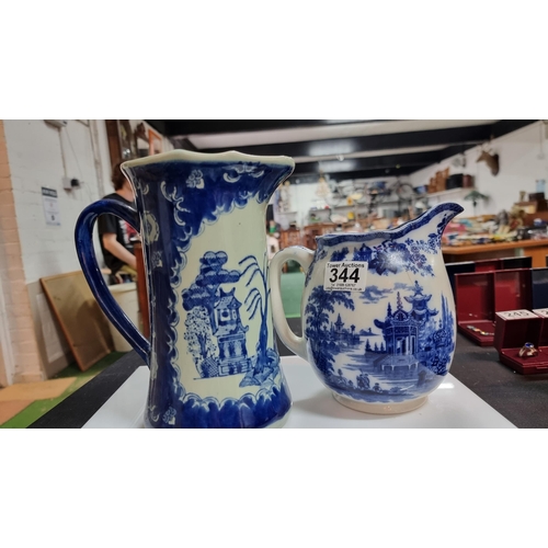 344 - Three pieces of blue & white china including a tall Chinese willow blue & white jug. Old Willow blue... 