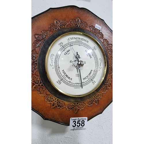 358 - Leather framed Welsh barometer with an embossed acorn design. Dial is in Welsh & English made by Ala... 