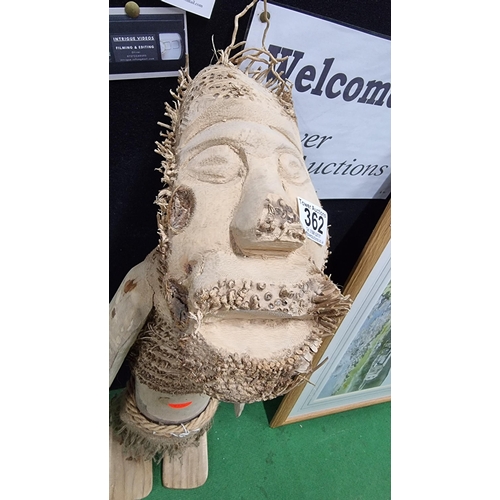 362 - Unusual tall wooden figure of a man with a beard in a grass skirt. In good condition. Measures heigh... 