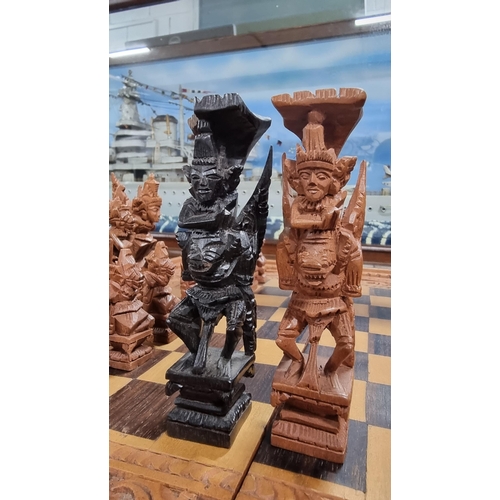 366 - Good quality Balinese Indonesian wooden hand carved deity chess set with intricately hand carved fig... 