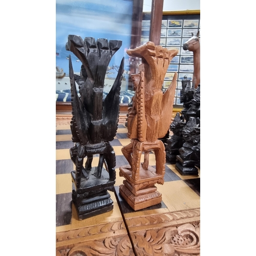 366 - Good quality Balinese Indonesian wooden hand carved deity chess set with intricately hand carved fig... 