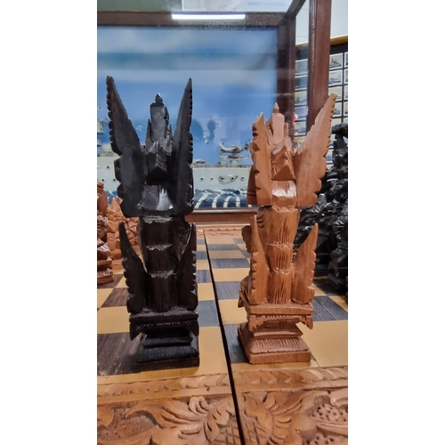 366 - Good quality Balinese Indonesian wooden hand carved deity chess set with intricately hand carved fig... 