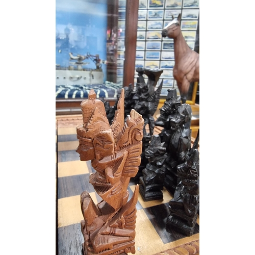 366 - Good quality Balinese Indonesian wooden hand carved deity chess set with intricately hand carved fig... 