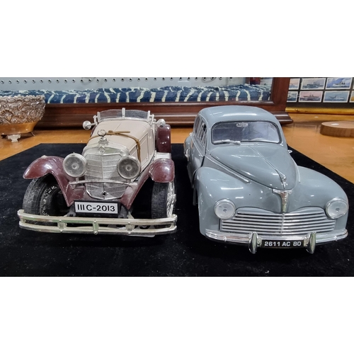 369 - Two large model diecast cars one of Mercedes Benz SSK by Burago the other is Peugeot 203 - 1954 by S... 