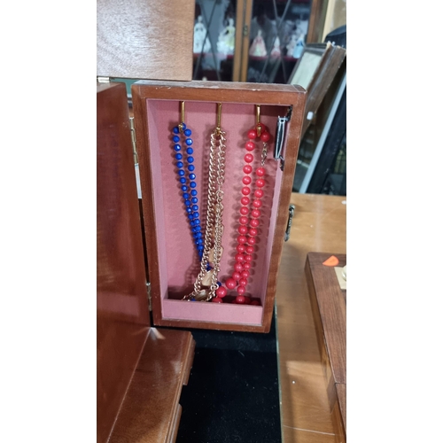 383 - Fitted wooden jewellery box with four drawers complete with costume jewellery. Measures height 29.5c... 