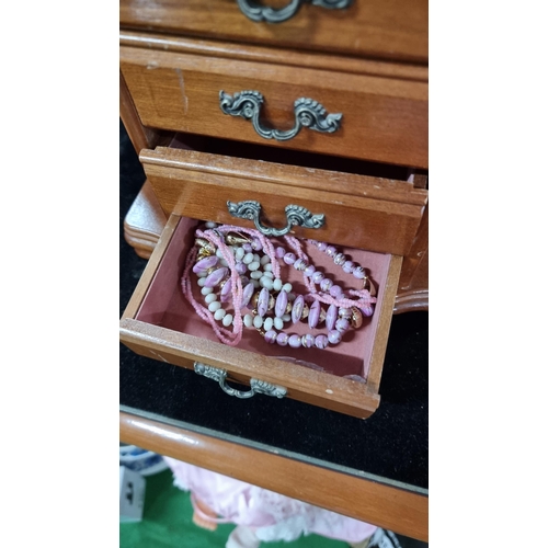 383 - Fitted wooden jewellery box with four drawers complete with costume jewellery. Measures height 29.5c... 