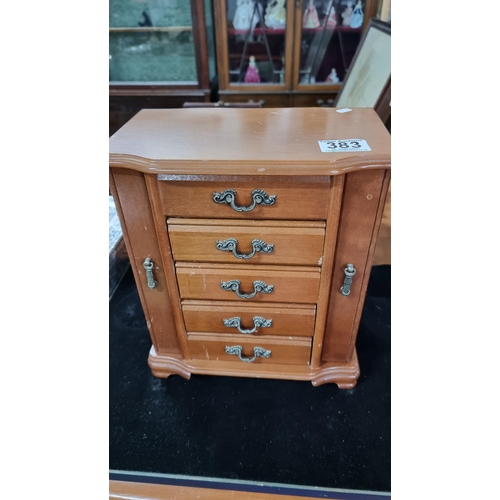 383 - Fitted wooden jewellery box with four drawers complete with costume jewellery. Measures height 29.5c... 