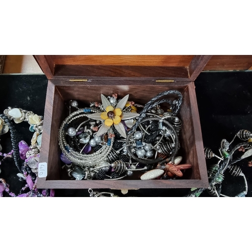 384 - Mahogany wooden box with brass butterflies to the top complete with a quantity of costume jewellery.... 