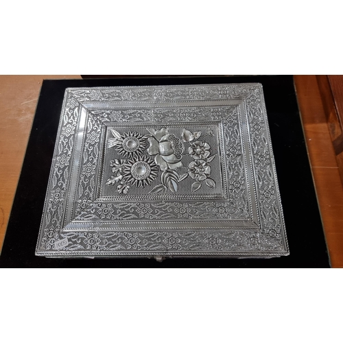 385 - Pretty ornate embossed silvered jewellery box with a flower design to the top revealing a fitted fel... 