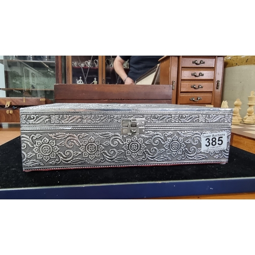 385 - Pretty ornate embossed silvered jewellery box with a flower design to the top revealing a fitted fel... 