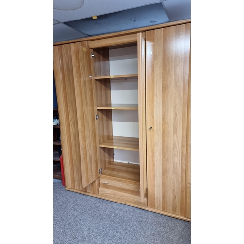 484 - Good quality modern French oak effect large triple wardrobe with two mirrored doors to the centre & ... 