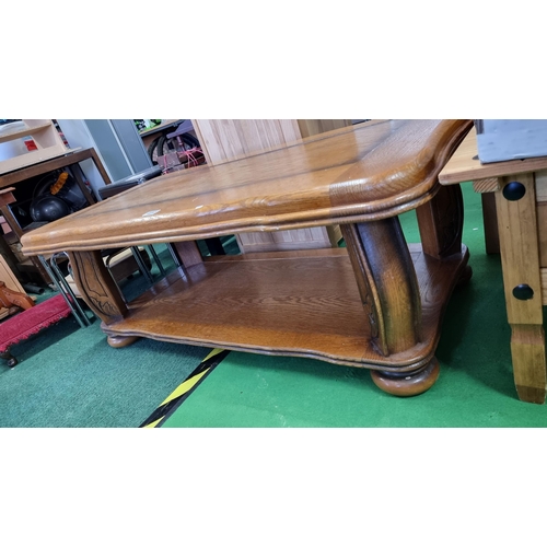 490 - Chunky solid oak coffee table with ornate carved legs. Measures 47cm height, 124cm length, 64cm dept... 