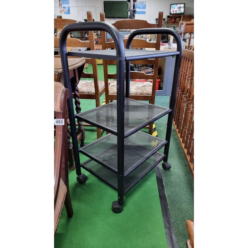 496 - Black metal four shelf trolley on castors ideal for computer or Hi-Fi systems. In good clean conditi... 