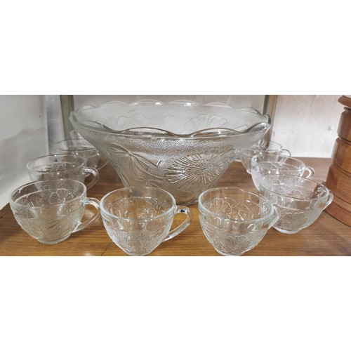 123 - Large Thick glass Punch bowl with a quantity of 9x thick glass cups has a decorative floral design a... 