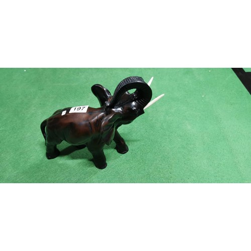 197 - Well-made resin elephant figure in a charging stance, has a very good realistic look. Measures 24cm ... 