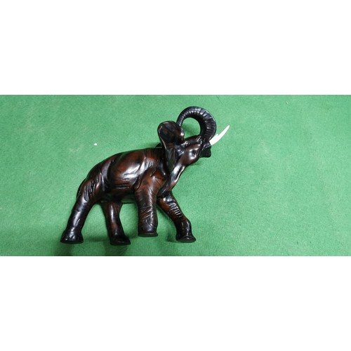 197 - Well-made resin elephant figure in a charging stance, has a very good realistic look. Measures 24cm ... 