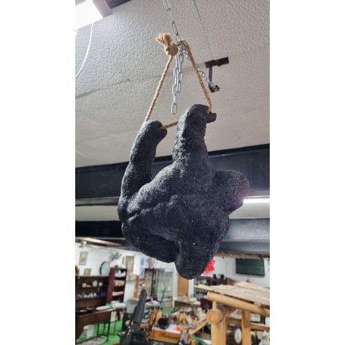 489 - Boxed as new large resin hanging Gorilla figure with a flower ring height 32cm, length 40cm width 20... 