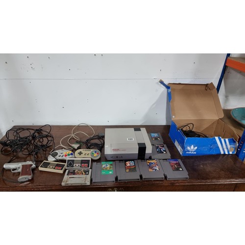 490 - Nintendo entertainment system console with 7 games 4x controllers a scorpion laser gun complete with... 