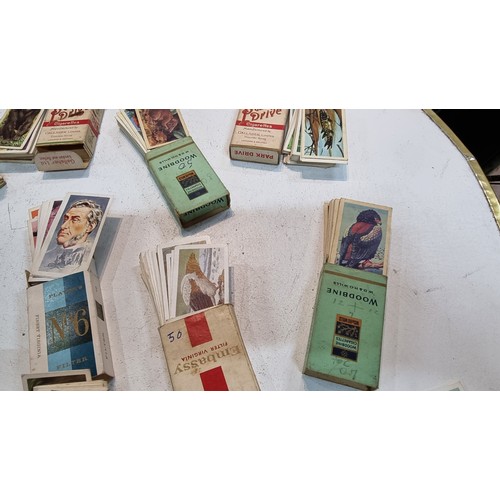 87 - Large quantity of various cigarette boxes all containing complete sets of cigarettes cards along wit... 