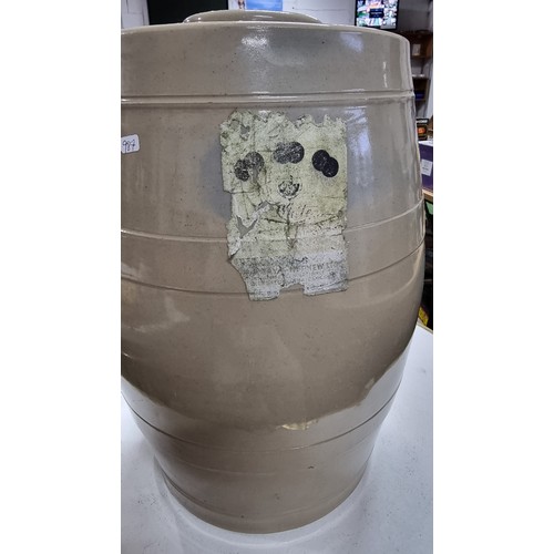 110 - Large stoneware barrel with a lid to the top and its original sticker attached for C White, all in e... 