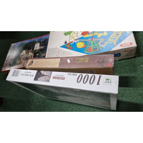 111 - A box full of new and sealed puzzles 8x in total inc a 3000 piece puzzle along with a box of various... 