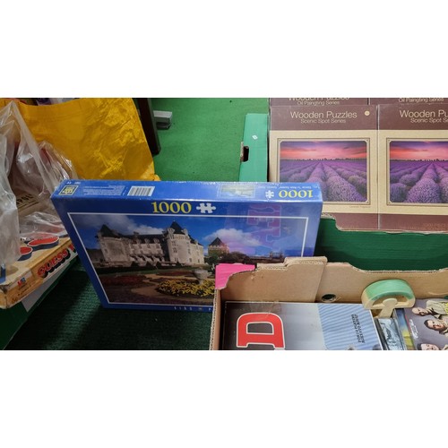 111 - A box full of new and sealed puzzles 8x in total inc a 3000 piece puzzle along with a box of various... 