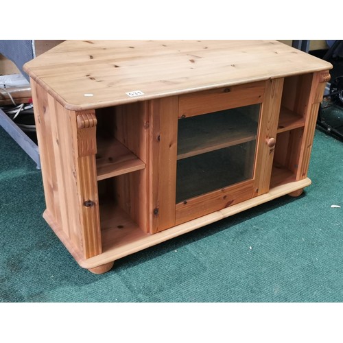 531 - Pine TV entertainment unit with a central glazed door.